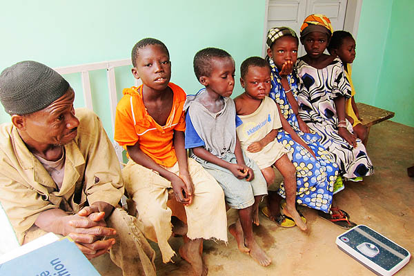 A father and some patients wait for their measles treatment